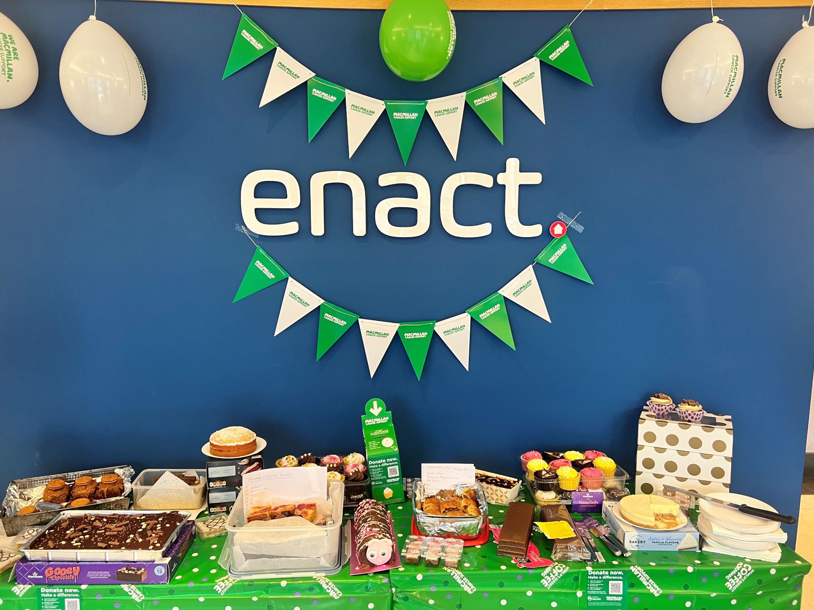 enact logo and cake table